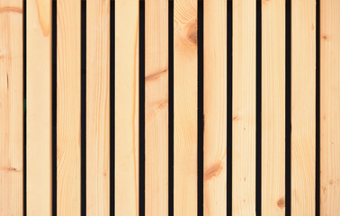Texture of a light yellow wooden wall of planks without painting. New and fresh wooden wall