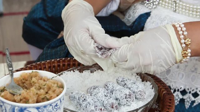 Thai dessert coconut, sugar and boiled minced shrimp wrap with sticky rice flour pad rolling in minced coconut : Kanom Tua Pab.