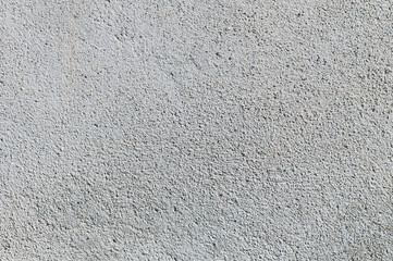 Gray textured cement wall background with fine concrete chips. Construction backgrounds
