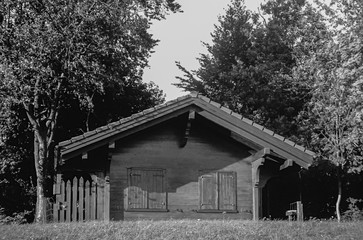 An old wooden cottage on the Swiss hills near Zurich shot with black and white analogue film technique