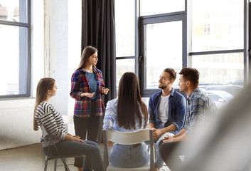 Fototapeta premium Psychotherapist working with patients in group therapy session indoors