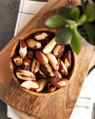 A handful of Brazil nuts on a wooden plate.