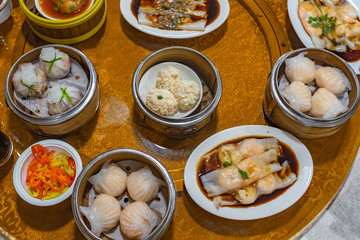 Assortment of delicious dimsum dumplings and rice rolls on table