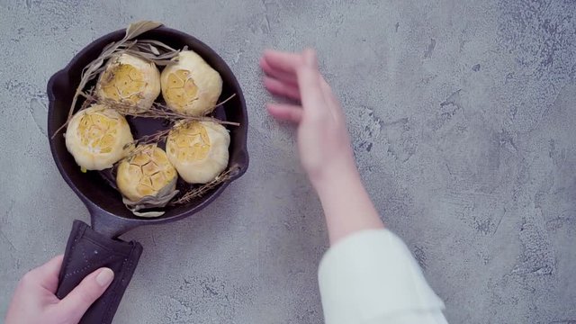 Roasted garlic spread recipe made with spices in cast iron skillet.