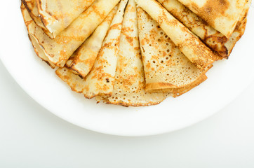 Russian style pancakes on a white plate studio shot