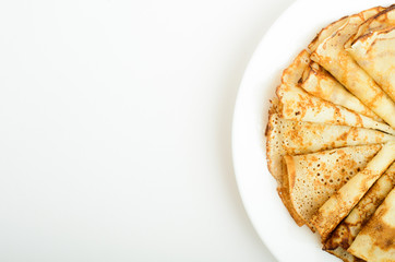 Russian style pancakes on a white plate studio shot
