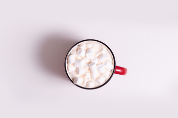 red mug with cocoa and marshmallows on a light background, top view