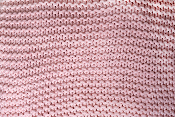 Texture pink knitted sweater. The concept of comfort and soft clothes. Knitting concept.