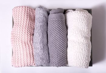 home comfort, textile, knitted, women's clothing, cotton, folded in a wooden box. concept of order, comfort, close-up, light background, top view