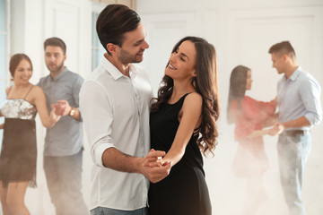 Lovely young couple dancing together at party