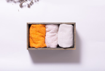 textile things towels, napkins, linen, cotton, dry lavender flowers, wooden box on the concept of order, comfort, close-up, light background, copy space