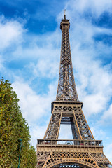 Fototapeta na wymiar Eiffel Tower on a background of bright blue sky. Vertical.