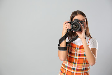 Professional photographer working on light grey background in studio. Space for text