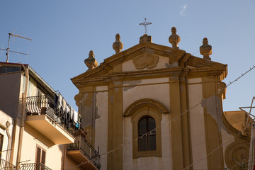  ancient church of Sicily, typical glimpse of southern Italy with clothes drying in the sun