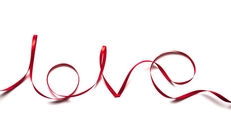 The word love from satin ribbon. Valentines day. White background