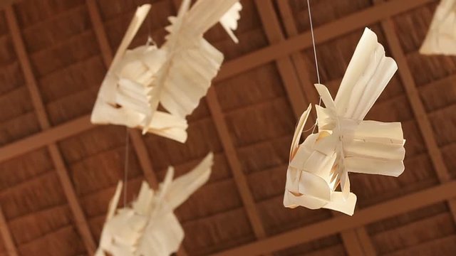 Thai traditional wind mobile weaving from lan or palm leaves in form of thai carp fish; Mobile Pla Ta-Piean. slow motion.