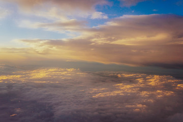 Naklejka na ściany i meble clouds at sunset from iljuminatora plane sky Sun travel