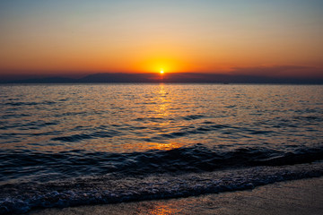 Dramatic sunset over sea and mountain. Photographed in Pirgos Sani on Halkidiki Greece.