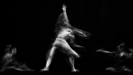 scenography of dancers dancing in black and white, blurred effect photography