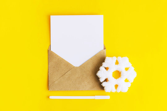 White paper in an envelope on a yellow background.