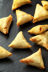 Fresh Indian Samosa with dipping sweet chili sauce on rustic stone board