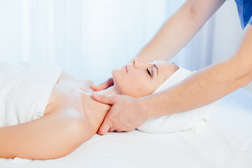 Fototapeta na wymiar doctor cosmetologist doing facial massage girl spa