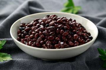 Canned Black Beans in white bowl. Healthy food