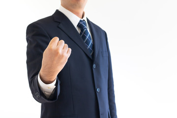 握りこぶしをしているスーツを着た男性