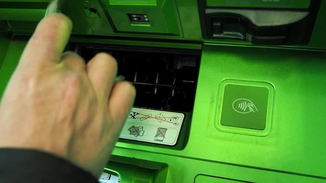 Close-up male hand takes money 1000 rubles from the ATM. Russian banknotes. The concept of getting a paycheck to repay a loan, pay utility bills and shop. Terminal for cash withdrawal.