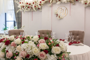 The table in the restaurant is decorated with a beautiful floral arrangement on the wedding day