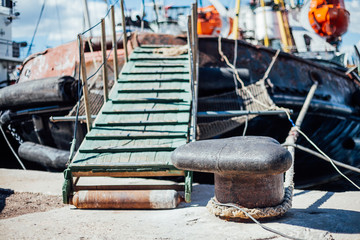 the ship is moored to a dock ladder rope chain