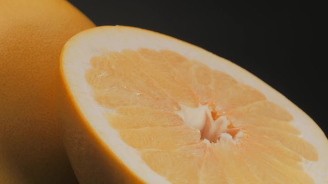 Tasty orange pomelo fruit, orange lith pulp rotating closeup
