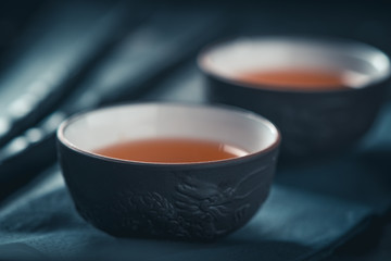 Asian tea ceremony. Chinese ceramic tea cups on stone dark background