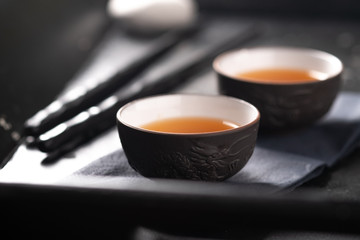 Asian tea ceremony. Chinese ceramic tea cups on stone dark background