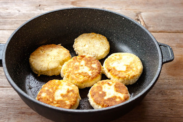 Russian syrniki baked fried cottage cheese pancakes curd fritters breakfast in cast iron skillet