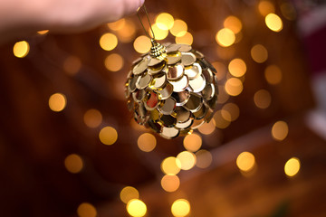 Closeup of gold toy Christmas ball decorations whith bokhe on buckground