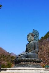 Fototapeta na wymiar panoramic view on The Great Unification Buddha (Tongil Daebul) at Shinheungsa temple, Seoraksan National Park, Sokcho, South Korea, horizontal