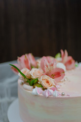 Delicate pink wedding cake with natural fresh beautiful flowers roses and lily. How To Put Fresh Flowers On A Buttercream Cake. Adding fresh flowers on a cake