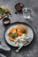 Buratta italian cheese with fruits served on handmade plate