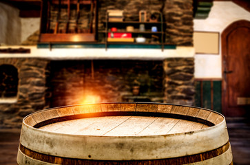 Wooden top of old barrel and blurred background of fireplace 