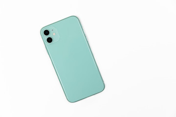 Smart phone light green color with two cameras isolated on a white background top view