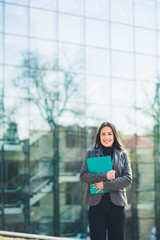 Fototapeta premium Portrait of beautiful business woman standing outside