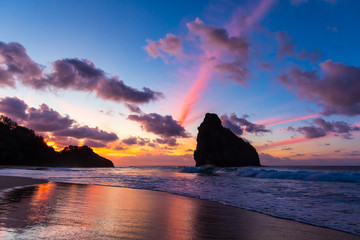 Stunning colorful sunset in Cacimba do Padre beach in Fernando de Noronha, Brazil with water...