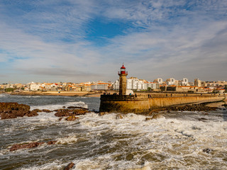 Porto, Portugal. 16 November 2019. Felgueiras Lighthouse standing on a quay at the stormy Atlantic coast off Porto on a sunny autumn day.