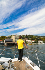 Fototapeta premium Woman traveller in a yellow t-shirt on a private yacht during Bosphorus cruise in Istanbul Turkey.