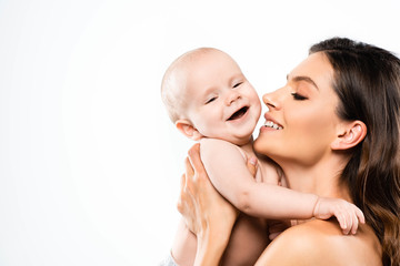 portrait of naked mother holding laughing baby, isolated on white