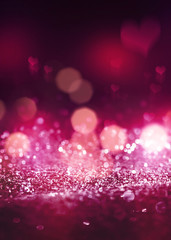 Hearts on a sparkling shiny background. Red abstract background. Blurry bokeh, neon light.