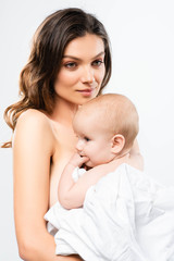 portrait of happy naked mother hugging baby boy, isolated on white