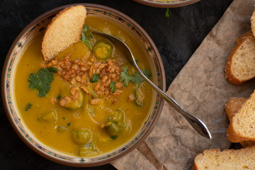 Vegan pumpkin and okra soup   topped with crispy onions