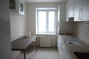 Fototapeta na wymiar Interior of a modern kitchen in white in minimalist style